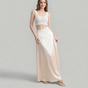 Women's white crochet crop top and champagne satin long skirt set with elegant finish