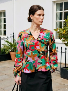 Detail of V-neck floral print blouse with abstract pattern on lightweight fabric
