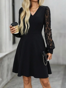 Detailed view of sheer black floral lace sleeves and elegant V-neckline of the dress