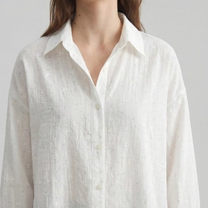 Elegant white long sleeve shirt with floral texture and button-up lapel for women