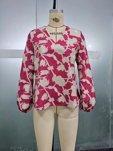 Detailed view of women's V-neck floral shirt with elastic cuffs and pink rose print