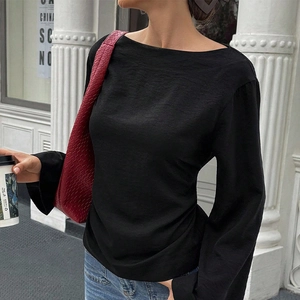 Elegant black boat neck long sleeve shirt with textured fabric for a minimalist city look