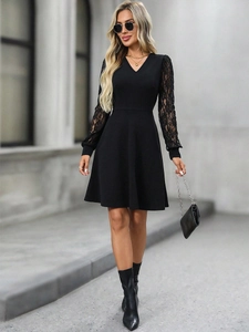 Detail of elegant black V-neck A-line dress with intricate lace long sleeves and high waist