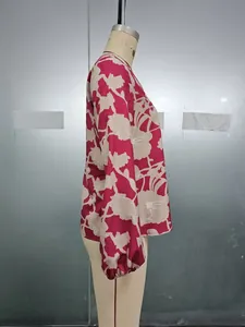 Detail of floral printed blouse showing elastic cuffs and pink polyester fabric