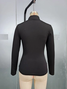 Rear view of a tight-fitting black mock neck long sleeve top for women on a mannequin