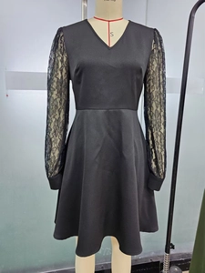 Detail of elegant black lace sleeves with floral embroidery on a V-neck A-line dress