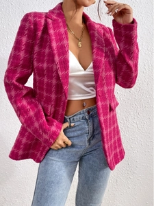 Detailed view of pink houndstooth plaid fabric texture and flap pocket on a women jacket