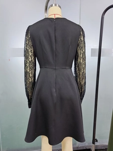 Detail of elegant black dress showing floral lace sleeves and invisible back zipper