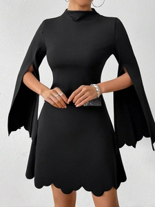 Detail of scalloped hem and slit flared sleeves on this slim black A-line dress