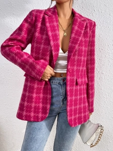 Close-up of bright pink tweed blazer jacket with houndstooth pattern and pocket detail