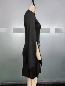 Detail of elegant black dress showing side slit sleeves and sparkling waist rhinestones