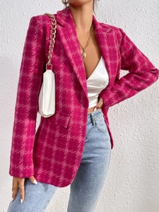 Detailed texture of pink tweed jacket featuring a notched lapel and classic flap pocket