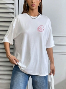 Detail of pink sun and moon art print on white oversized round neck t-shirt for women