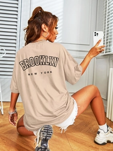Detailweergave van het oversized beige T-shirt met BROOKLYN-print en losse pasvorm