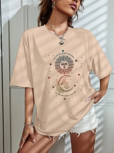 Close-up of vintage celestial sun and moon print on apricot loose fit cotton T-shirt