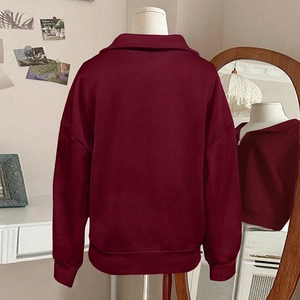 Women's burgundy oversized quarter-zip sweatshirt with a polo collar and dropped shoulders