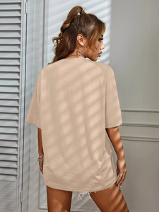 Side-back view of oversized khaki cotton T-shirt with premium texture and street style