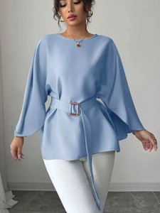 Detail of light blue satin blouse with flared sleeves and gold buckle waist tie belt