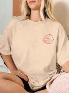 Detail of sand beige oversized t-shirt featuring pink star and moon chest print