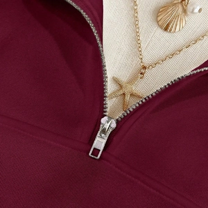 Burgundy half-zip sweatshirt for women with premium metal zipper detail and soft knit fabric