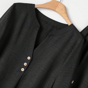 Women's black V-neck long sleeve top and pants set with rustic wood buttons texture