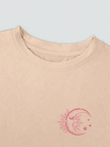 Detailed view of apricot crew neck T-shirt featuring a pink celestial moon print detail