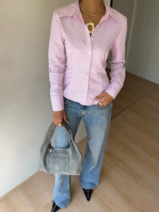 Detailed view of pink and white striped slim-fit shirt with button-down collar design