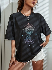 Detail of sun and moon print on oversized black t-shirt with spiritual quotes