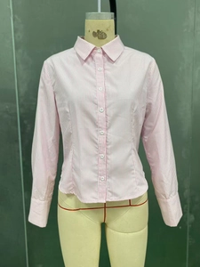 Detail showing the pink and white striped shirt with button-up front on a mannequin