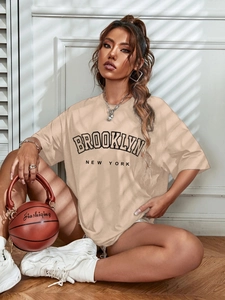 Oversized apricot Brooklyn t-shirt styled with a creative basketball handbag