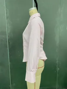 Detail of pink and white striped cotton shirt with waist pleats on mannequin