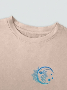 Detail of apricot T-shirt crew neck with blue sun and moon vintage print