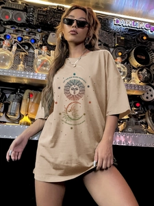 Detail of sun and moon astrology print on a beige loose fit cotton t-shirt