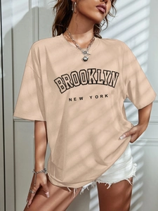 Detailed view of the Brooklyn New York print on a beige oversized cotton t-shirt