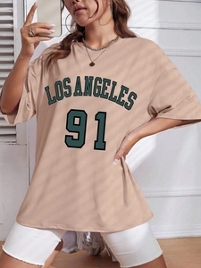 Detail of Los Angeles 91 print on a loose beige crew neck T-shirt with vintage style