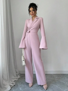 Detailed close-up of elegant mauve jumpsuit featuring stylish bell sleeves and side tie waist
