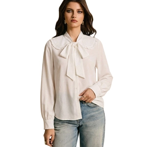 Elegant white long sleeve shirt for women featuring a large bow tie and ruffled collar