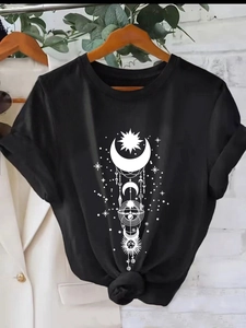 Black crew neck T-shirt with white celestial sun and moon print on a wooden hanger
