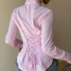 Chic pink striped long sleeve shirt for women featuring a stylish corset-style lace-up back