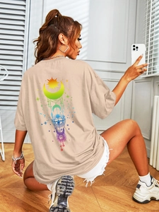Macro detail of sun and moon astrology print on the back of beige oversized T-shirt