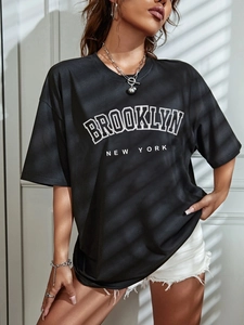 Detail of Brooklyn print on oversized black t-shirt with urban street style lighting