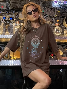 Brown oversized crewneck T-shirt with vintage sun and moon print in industrial setting