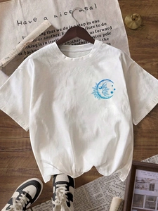 Women's casual white crewneck t-shirt with blue sun moon print on wooden floor