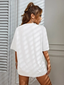 Detail view of a loose-fit white t-shirt featuring dropped shoulders and a minimalist cut