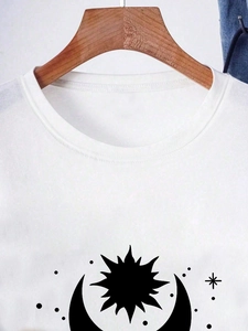 Detail of white cotton crew neck T-shirt with sun and moon graphic print design