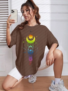 Detail eines dunkelbraunen Oversized-T-Shirts mit buntem Regenbogen-Himmelsdruck