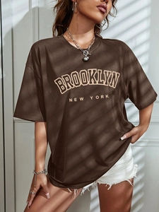 Detail of dark brown oversized cotton T-shirt with Brooklyn New York vintage print