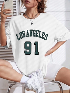 Women's oversized white t-shirt with green Los Angeles 91 print in retro athletic style
