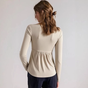 Chic beige long sleeve V-neck top with high-waist pleated back hem for women