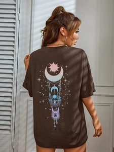 Detail of celestial sun and moon back print on an oversized dark brown cotton t-shirt